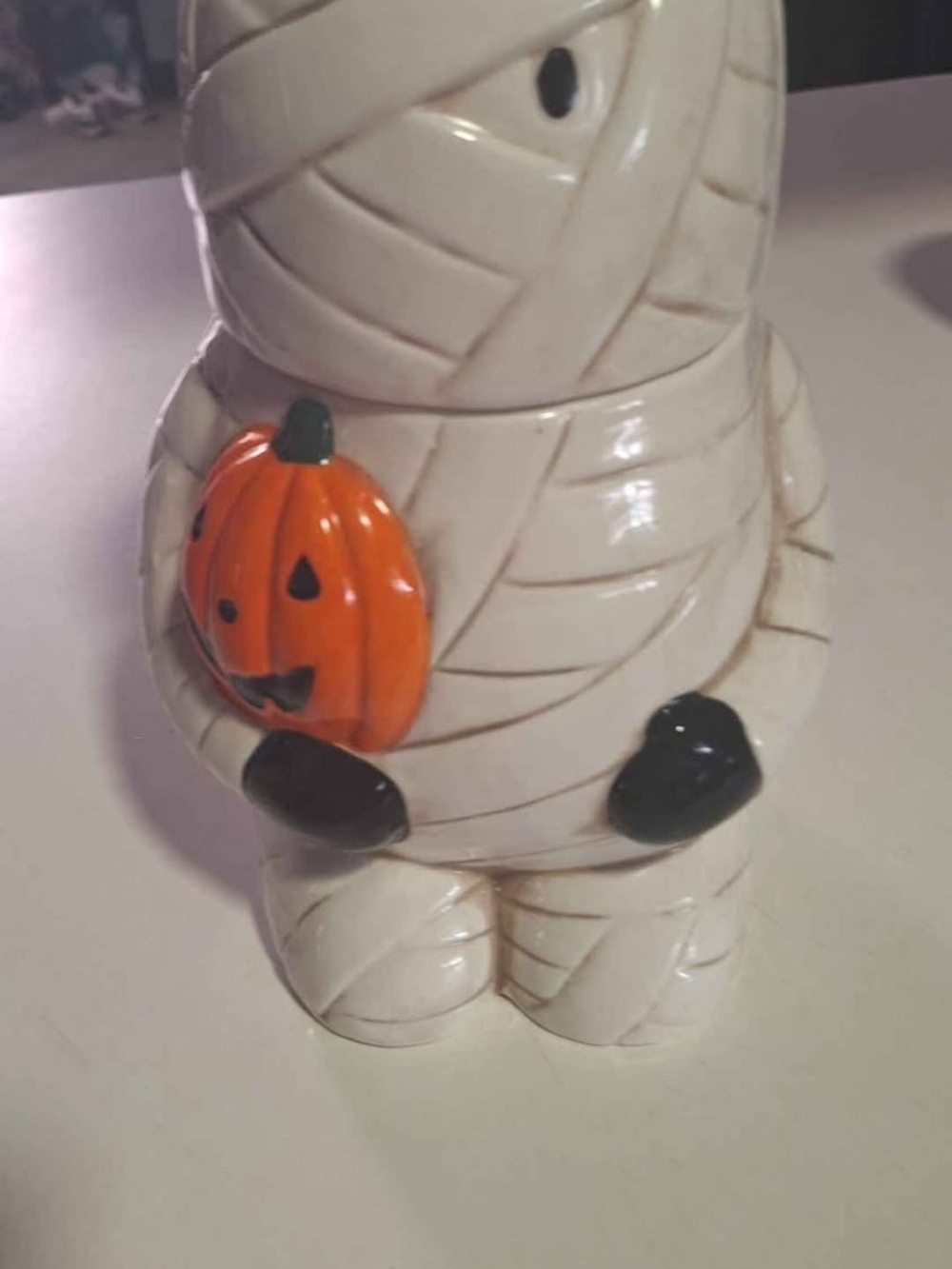 White Ceramic Mummy Figurine Holding Orange Pumpkin - Seasonal Decor